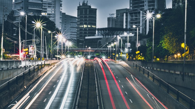 nativeMsg offers on-site conversational interfaces; chatbot tech advances rapidly, image depicts city highway, fast moving traffic, night skyline.
